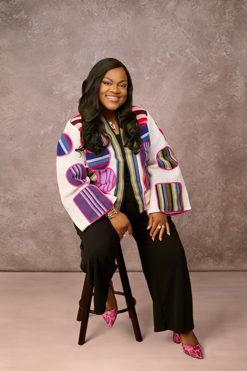 Busayo Disu in a woven jacket, smiling
