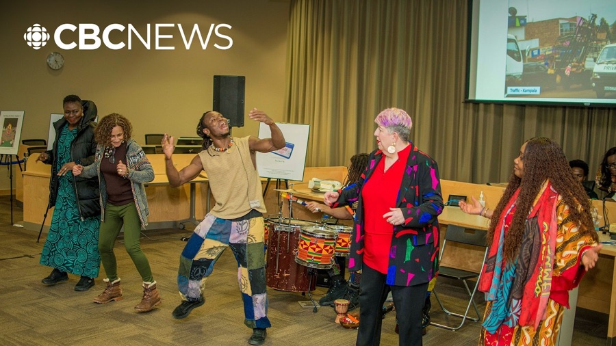 Drummers and dancers performing in a Strathcona County council chamber at a Black History Month event, under the CBC News mark
