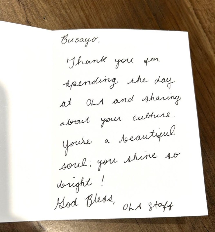 Handwritten card from OLA staff: Busayo, thank you for spending the day at OLA and sharing about your culture. You&rsquo;re a beautiful soul; you shine so bright! God bless, OLA staff.