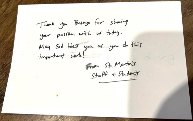 Handwritten card from St. Martin&rsquo;s staff and students: Thank you Busayo for sharing your passion with us today. May God bless you as you do this important work! From St. Martin&rsquo;s staff and students.